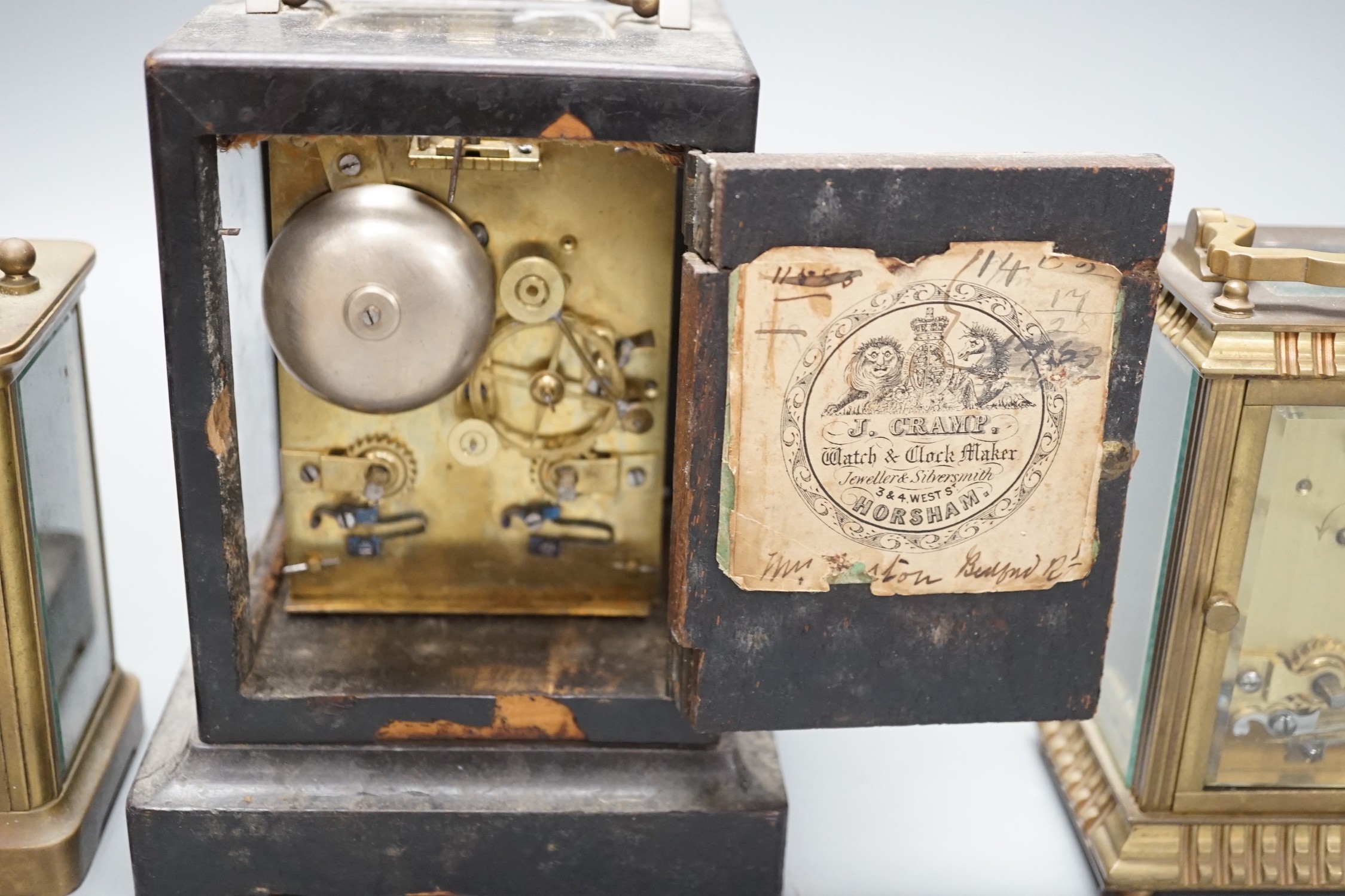 A mid 19th century French ebony veneered carriage clock, 16cm high with J. Cramp Horsham retailers label, a Mappin and Webb carriage clock, another by Mann of Gloucester, tallest 15cms high